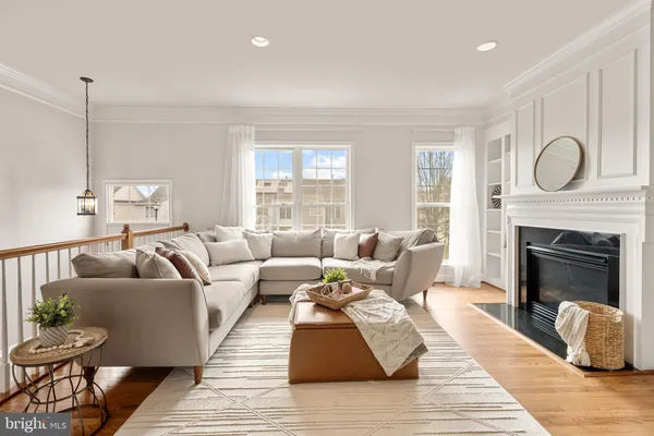 a living room with furniture a fireplace and a table