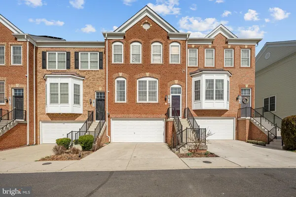 an empty room with ceiling fan and windows