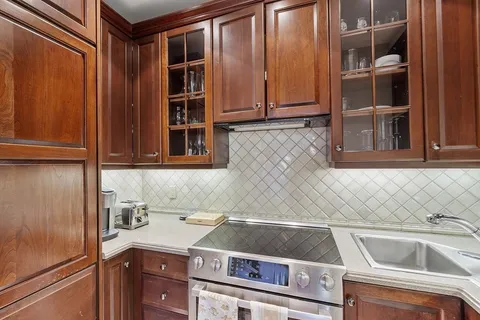a view of a kitchen with a sink and cabinets