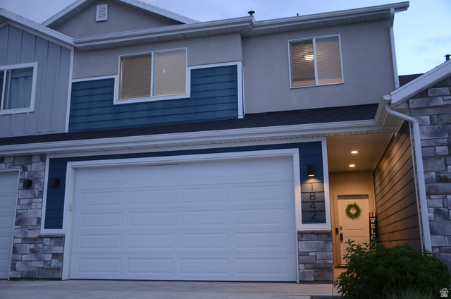 1842 South 1280th Street West Logan, UT 84321 - Photo 1 of 21 Contemporary exterior with mixed material facade, featuring blue horizontal siding, light gray vertical siding, and stone accents