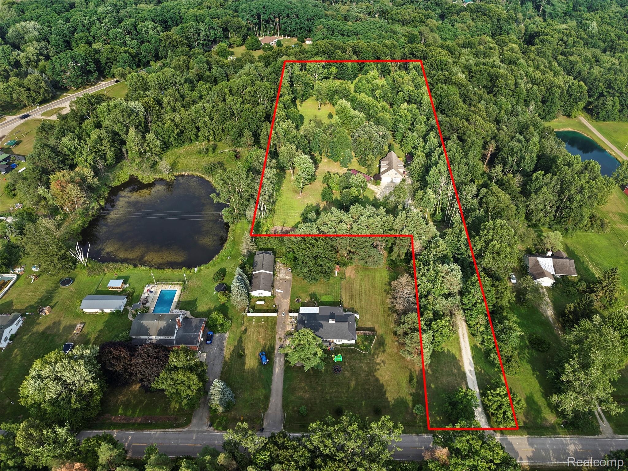 15055 South Duffield Road Byron, MI 48418 - Photo 58 of 61 Expansive property featuring a private pond, in-ground swimming pool, multiple structures, and extensive wooded areas
