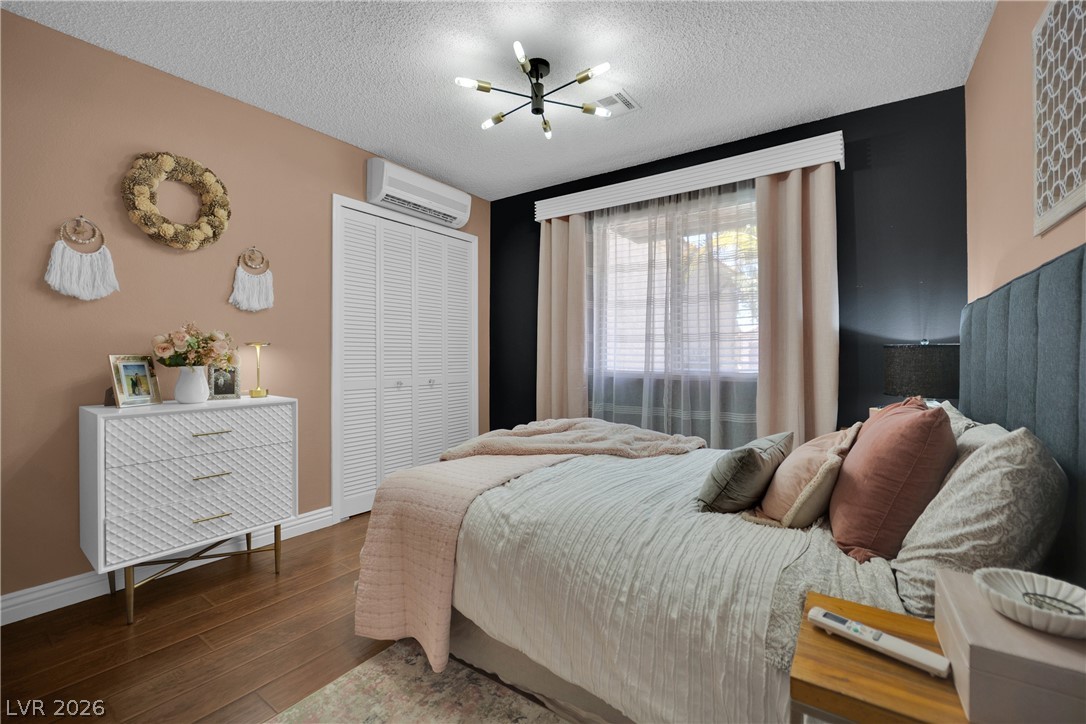 530 Grape Drive Henderson, NV 89015 - Photo 15 of 39 Rich hardwood floors create a welcoming atmosphere in this well-appointed bedroom.