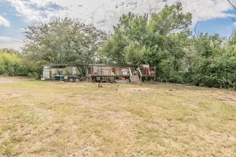 a view of a house with a yard and sitting area