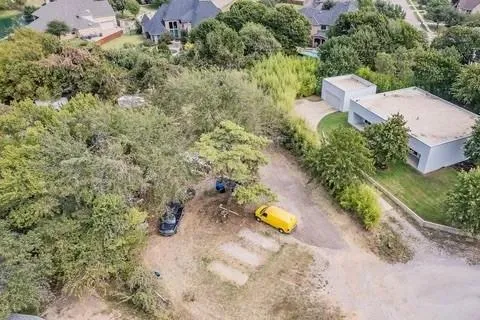 an aerial view of a house with a yard and lake view