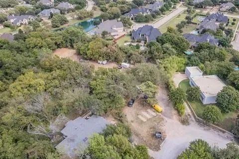 an aerial view of a houses with a yard