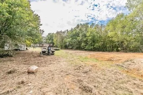 a view of outdoor space with deck and trees