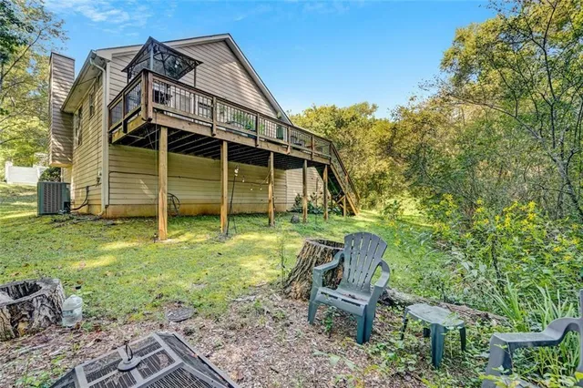 a view of a chair and table in backyard of the house