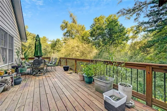 a view of a balcony with chairs and wooden floor