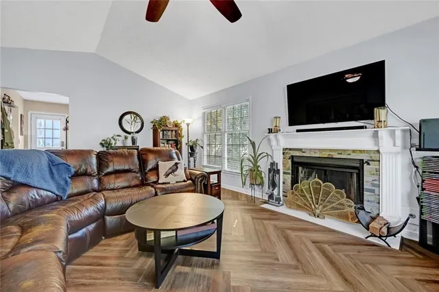 a living room with furniture flat screen tv and a fireplace
