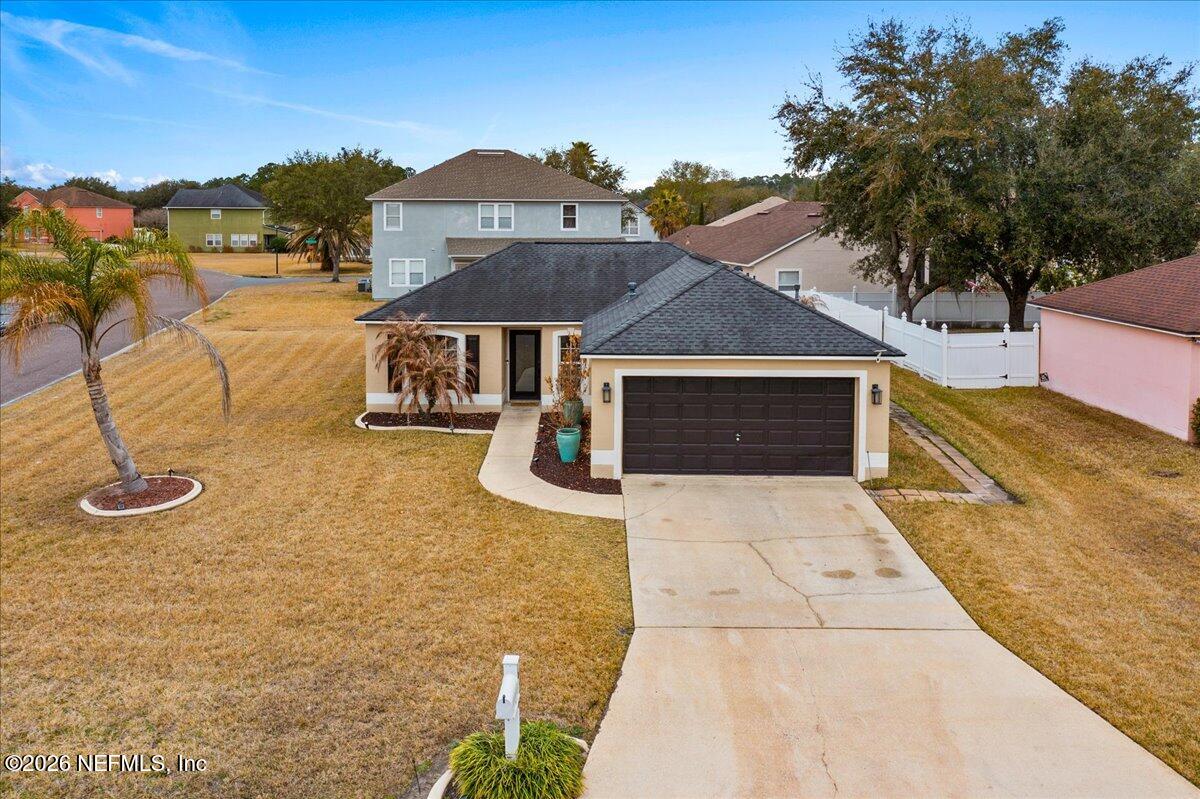 10310 Woodley Point Road Jacksonville, FL 32218 - Photo 2 of 30 a front view of a house with a yard