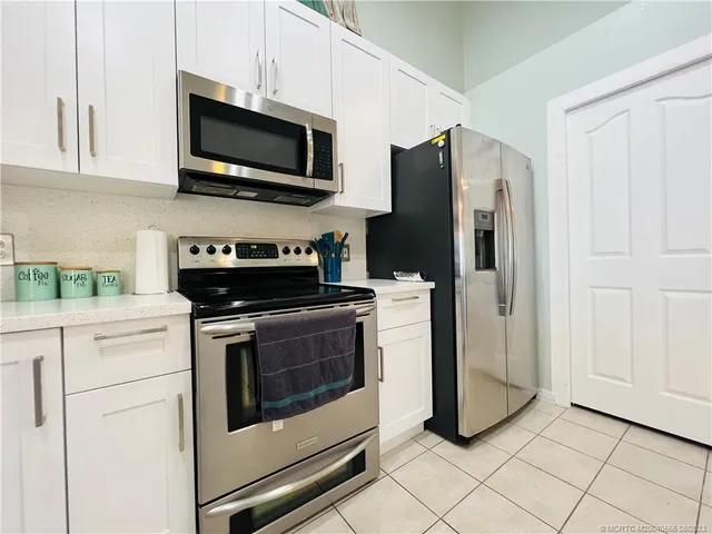 a kitchen with a sink cabinets and window