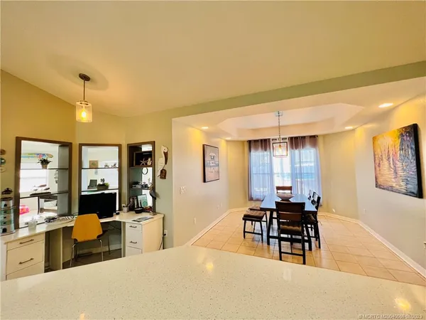 a view of a dining room with furniture and window