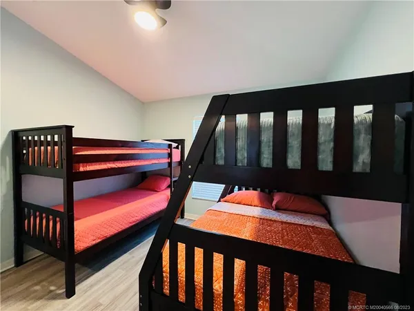 a spacious bathroom with a granite countertop sink a toilet and mirror