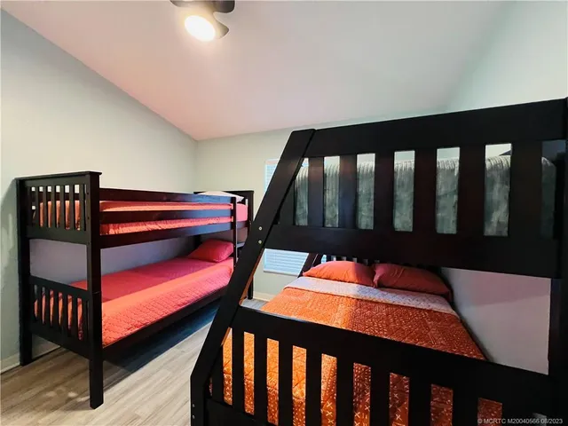 a spacious bathroom with a granite countertop sink a toilet and mirror