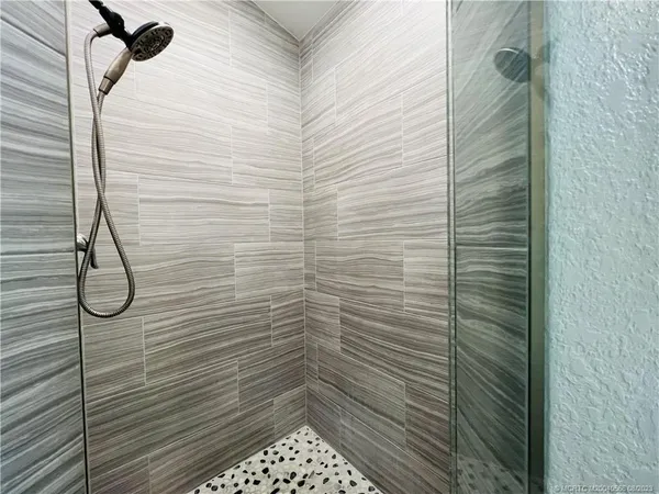 a view of a chairs and table in patio with wooden floor