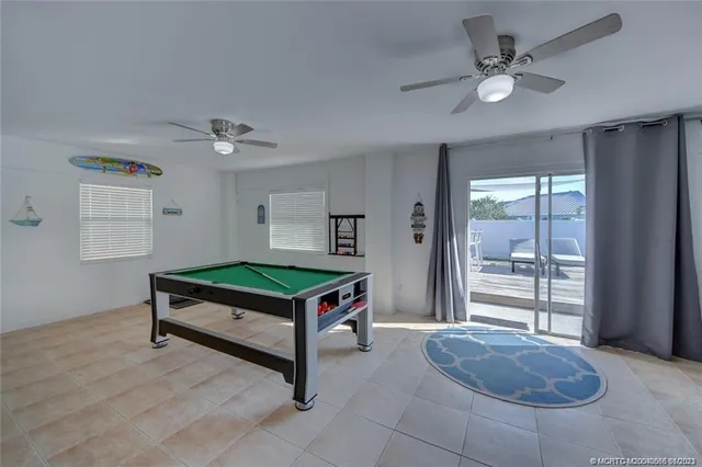 a bedroom with furniture and a large window