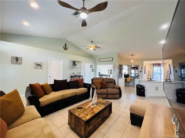 a living room with furniture ceiling fan and a rug