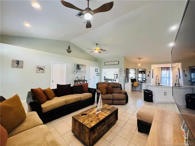 a living room with furniture ceiling fan and a rug