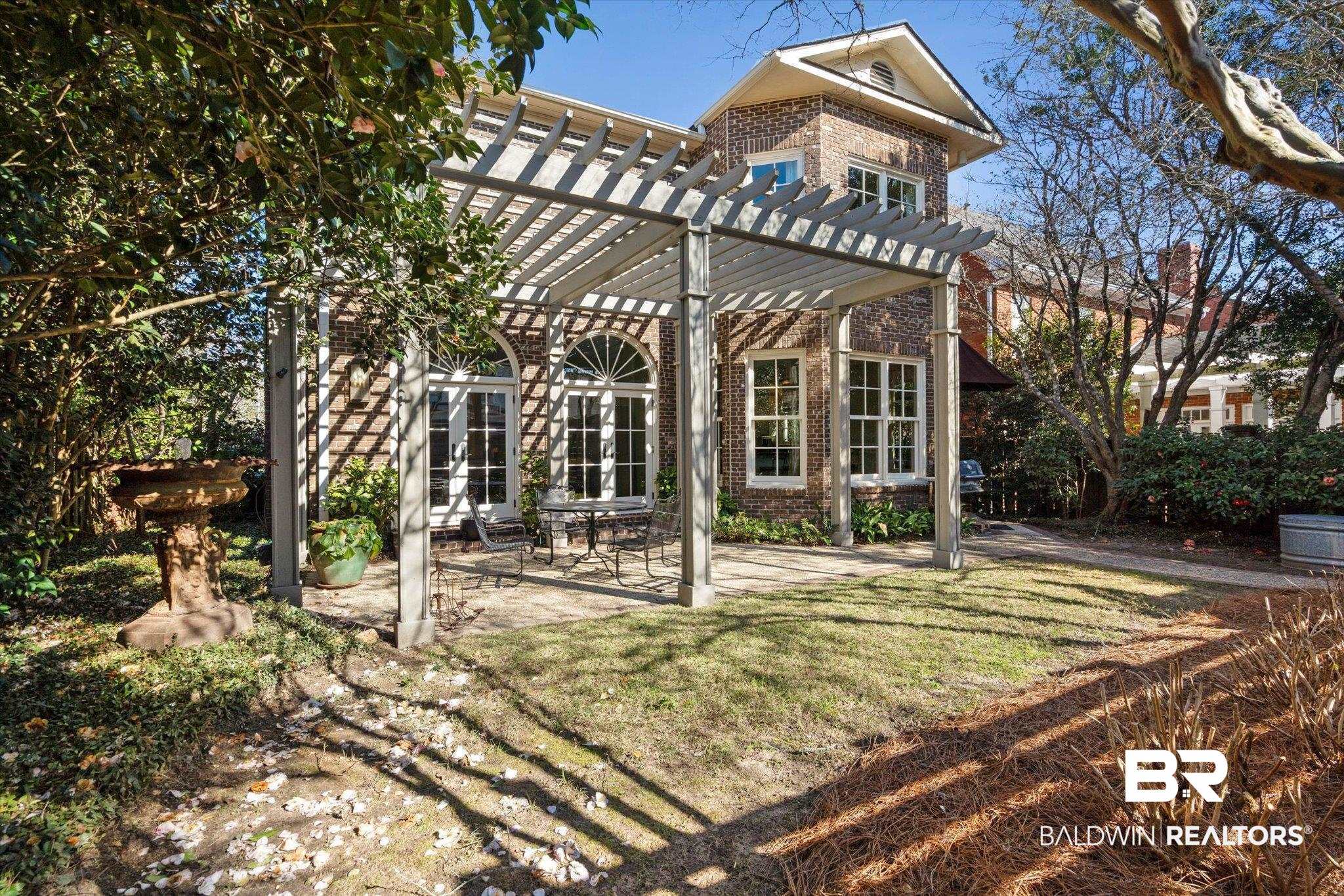 3615 Stein Street Mobile, AL 36608 - Photo 35 of 44 Rear view of property with a pergola, brick siding, a patio area, a yard, and french doors