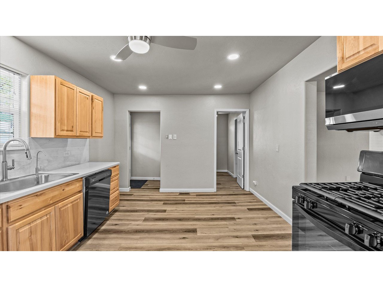 632 Minter Avenue De Beque, CO 81630 - Photo 11 of 26 a kitchen with kitchen island granite countertop a sink cabinets and stainless steel appliances