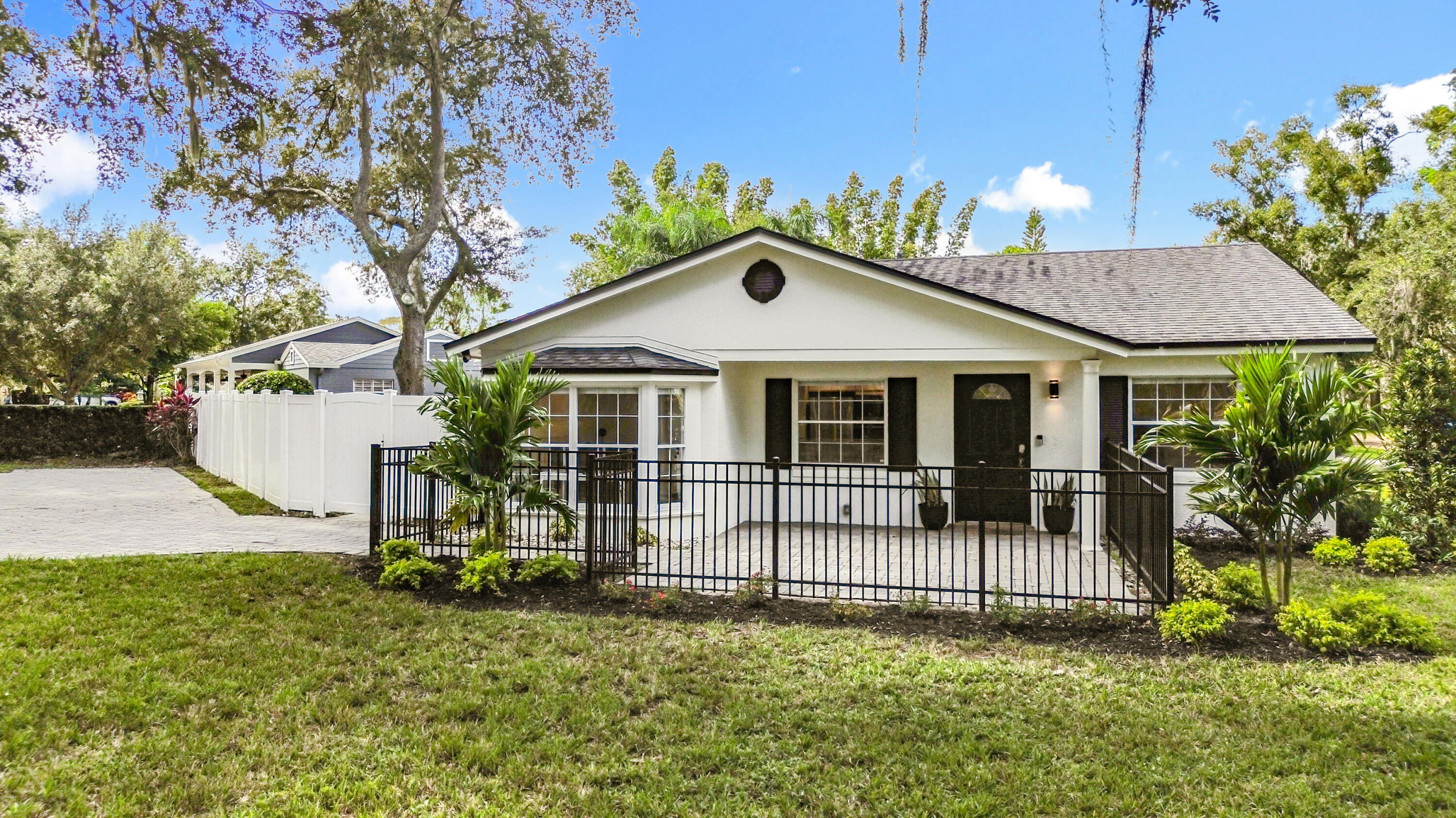 a front view of a house with a garden
