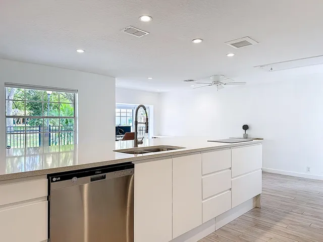 a kitchen that has a sink and a stove in it