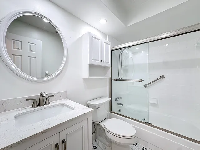 a spacious bedroom with a bed and a flat screen tv