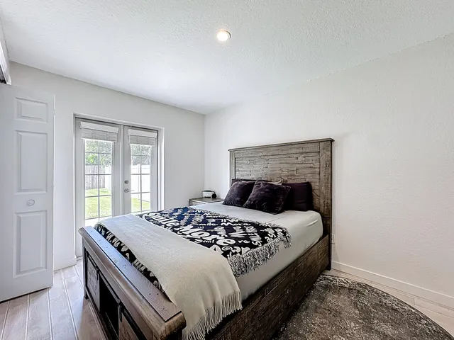 a bedroom with a bed and a flat screen tv