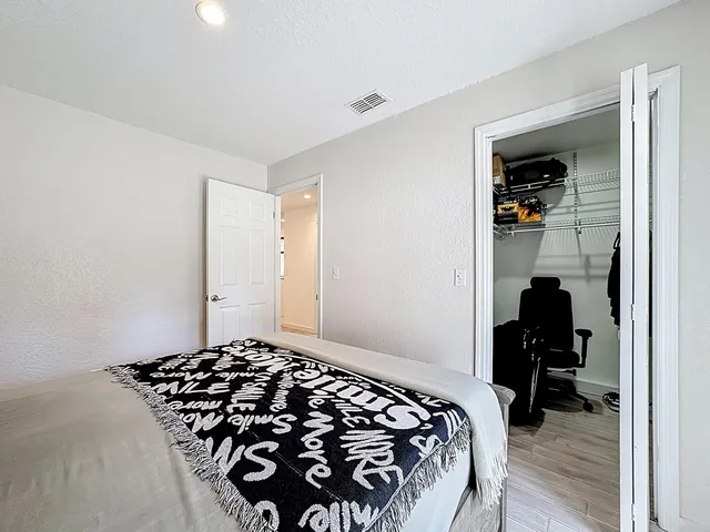 a bedroom with bed and a large window