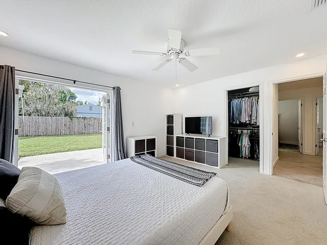 a backyard of a house with table and chairs