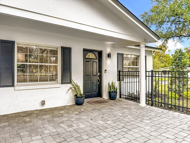 a view of a house with a wooden floor and a backyard