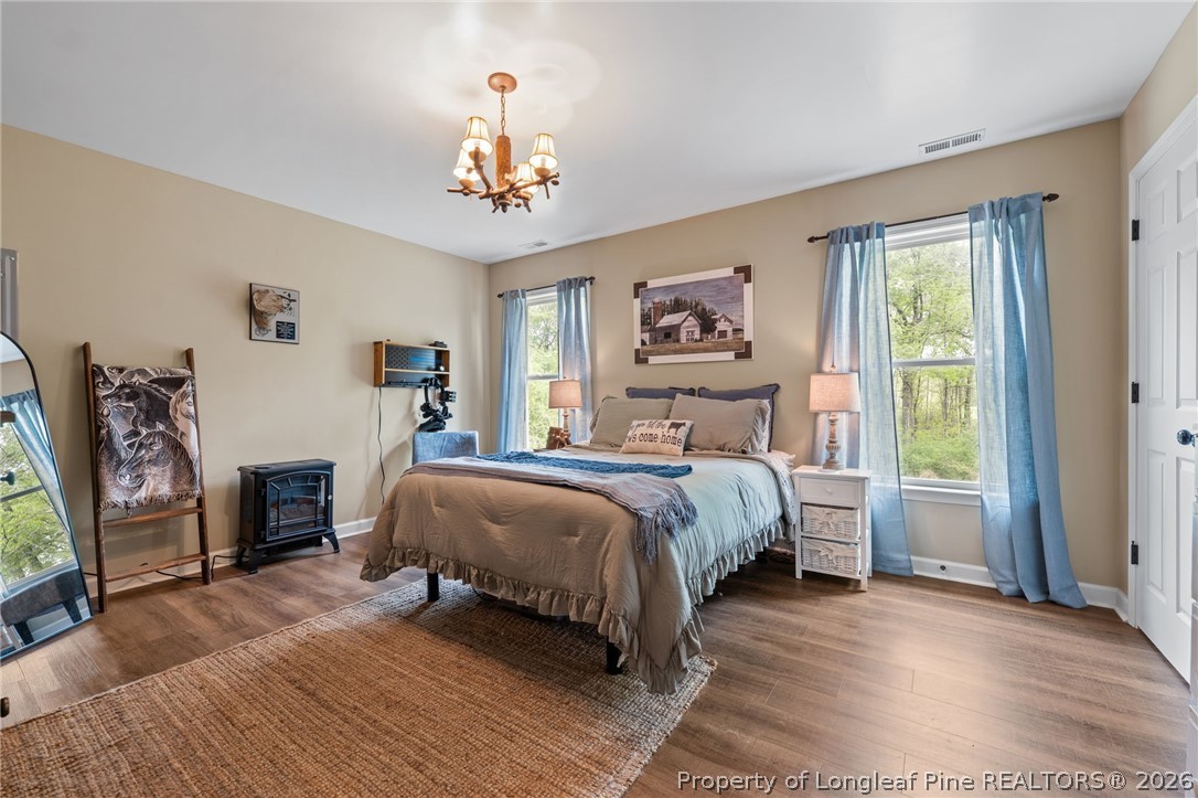 186 Lewis Brown Road Bennett, NC 27208 - Photo 22 of 48 a bedroom with a large bed and a window