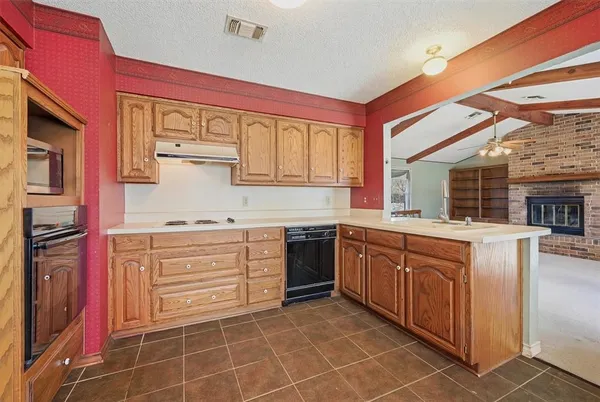 a kitchen with stainless steel appliances granite countertop a sink and cabinets