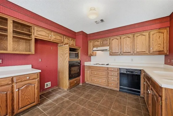 a kitchen with stainless steel appliances granite countertop a stove and a sink