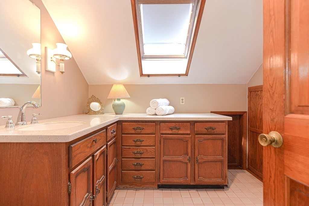 11 Wilde Road Wellesley, MA 02481 - Photo 17 of 26 a bathroom with a sink and a mirror