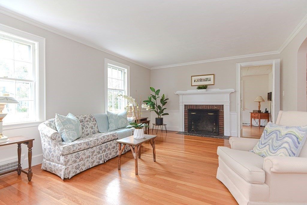 11 Wilde Road Wellesley, MA 02481 - Photo 2 of 26 a living room with furniture a fireplace and a table
