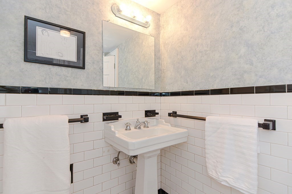 11 Wilde Road Wellesley, MA 02481 - Photo 22 of 26 a bathroom with a sink a mirror and shower