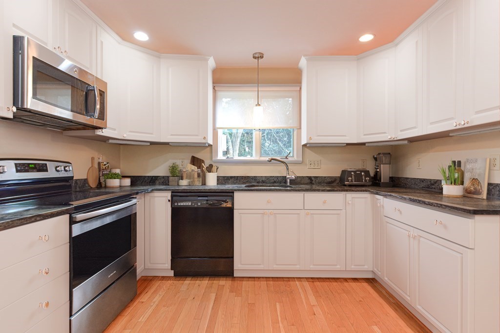11 Wilde Road Wellesley, MA 02481 - Photo 6 of 26 a kitchen with stainless steel appliances granite countertop a stove top oven a sink dishwasher and white cabinets with wooden floor