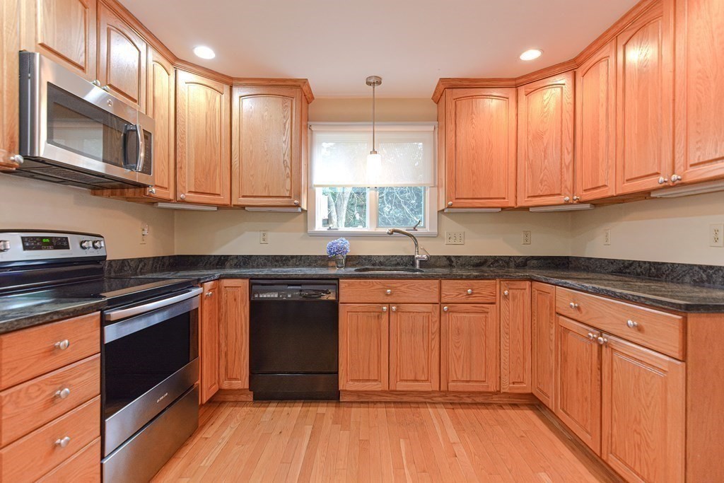 11 Wilde Road Wellesley, MA 02481 - Photo 7 of 26 a kitchen with stainless steel appliances granite countertop wooden cabinets a sink and dishwasher a stove with wooden floor
