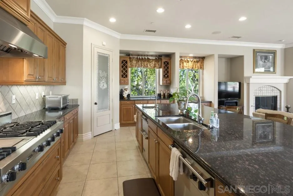 14032 Lake Poway Road Poway, CA 92064 - Photo 11 of 51 a kitchen with stainless steel appliances granite countertop a stove a sink and a refrigerator