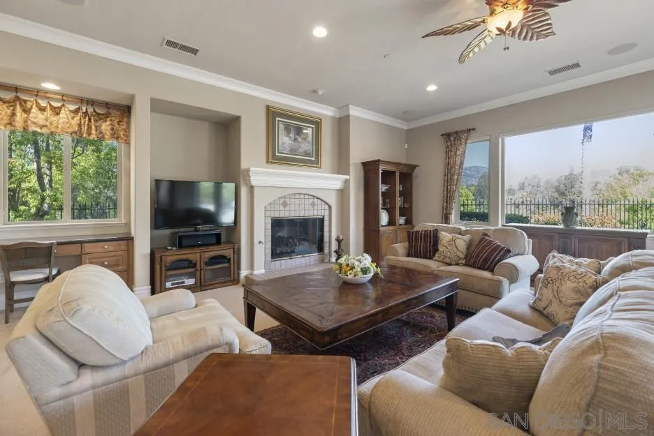 14032 Lake Poway Road Poway, CA 92064 - Photo 14 of 51 a living room with furniture a flat screen tv and a large window