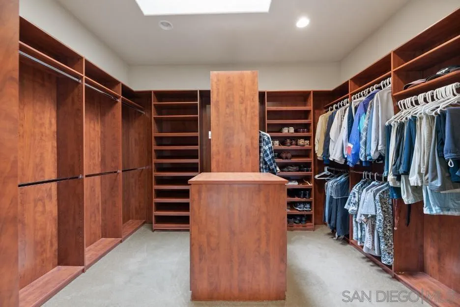 14032 Lake Poway Road Poway, CA 92064 - Photo 26 of 51 a view of walk in closet with clothes and shoes