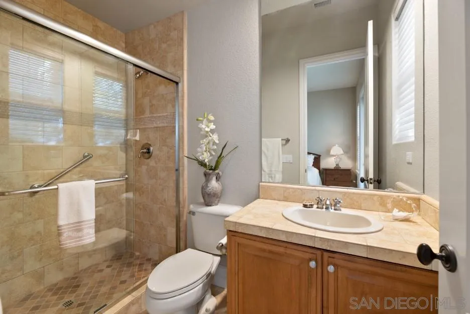 14032 Lake Poway Road Poway, CA 92064 - Photo 30 of 51 a bathroom with a sink toilet and shower