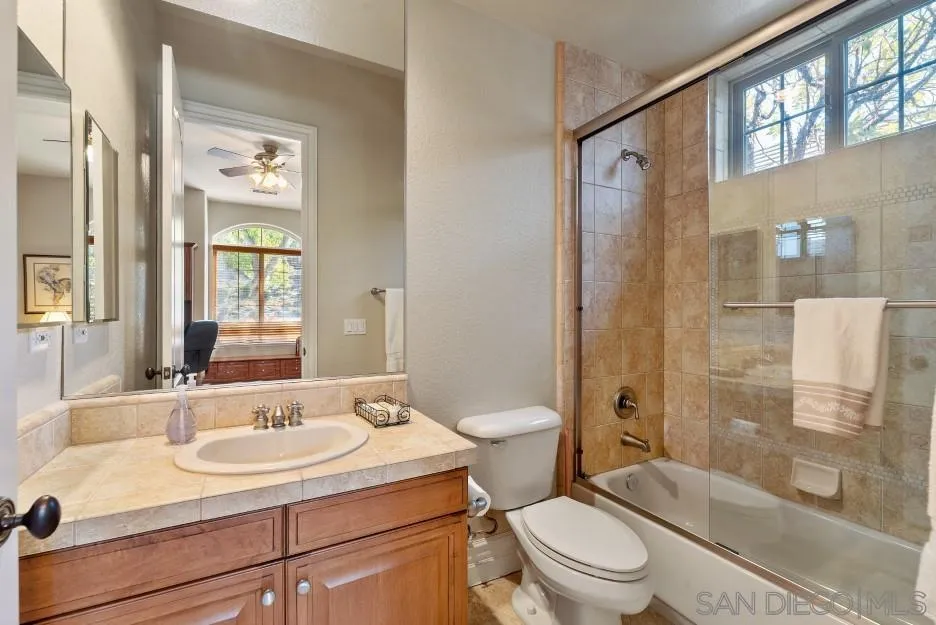 14032 Lake Poway Road Poway, CA 92064 - Photo 36 of 51 a bathroom with a sink toilet a mirror and shower