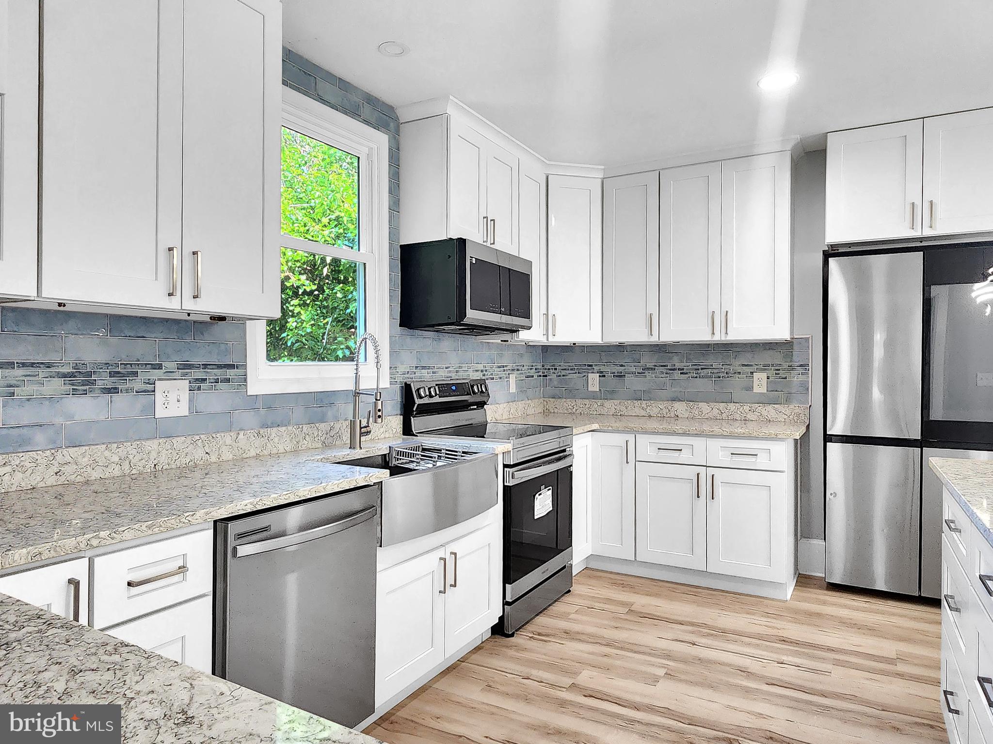 30181 Temperanceville Road Temperanceville, VA 23442 - Photo 12 of 41 a kitchen with cabinets stainless steel appliances and a window