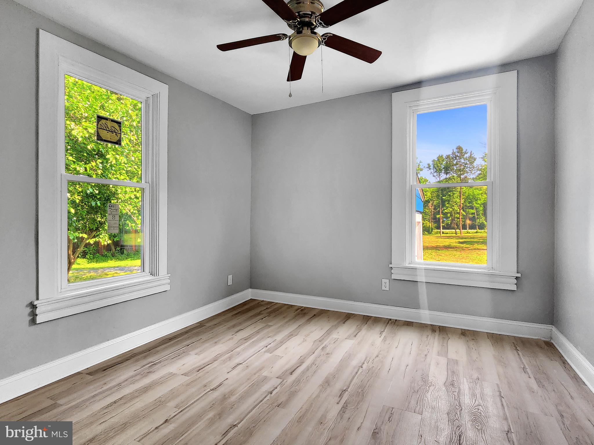 30181 Temperanceville Road Temperanceville, VA 23442 - Photo 16 of 41 a view of an empty room with a window and wooden floor