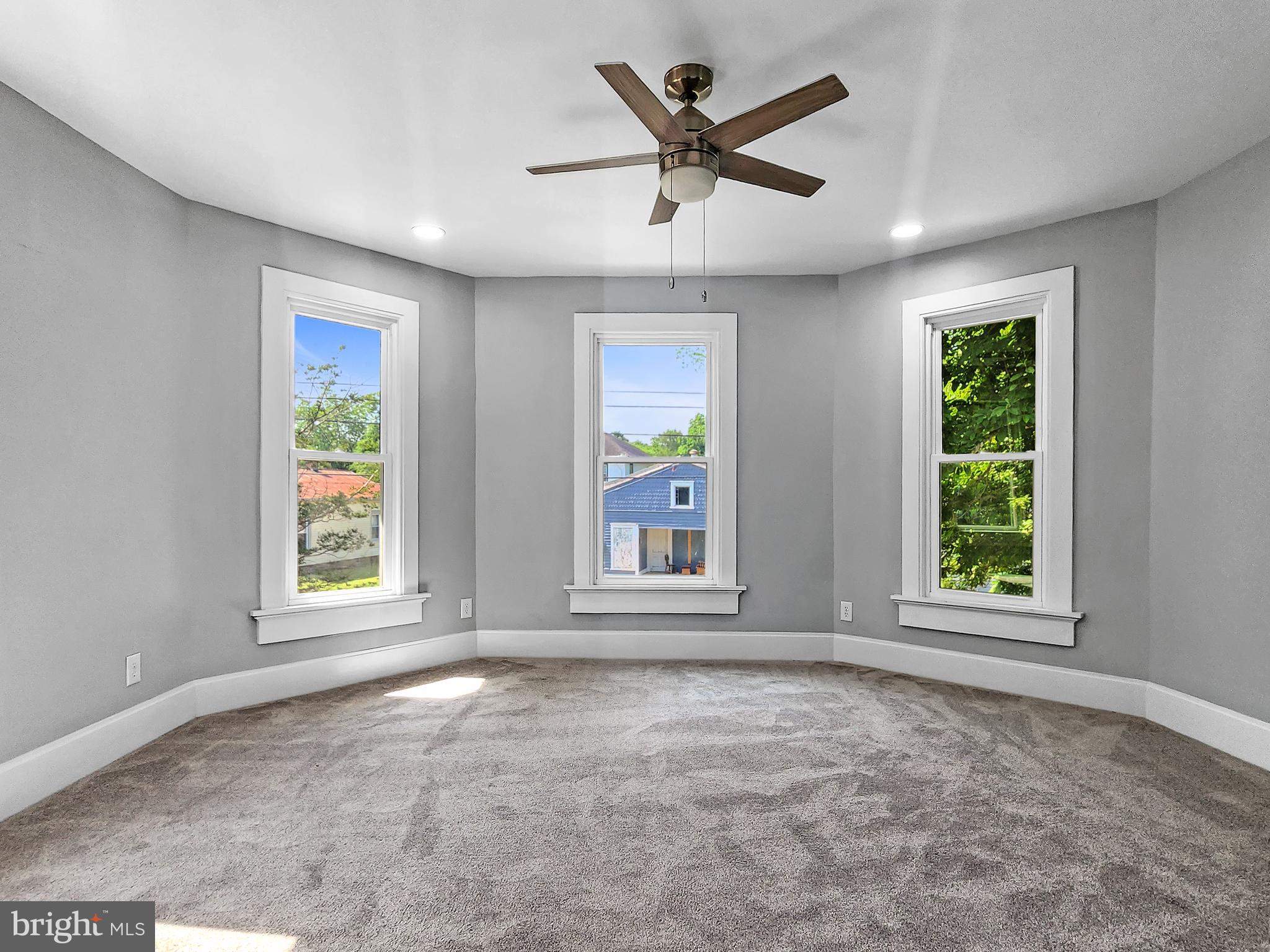 30181 Temperanceville Road Temperanceville, VA 23442 - Photo 24 of 41 an empty room with window ceiling fan and windows