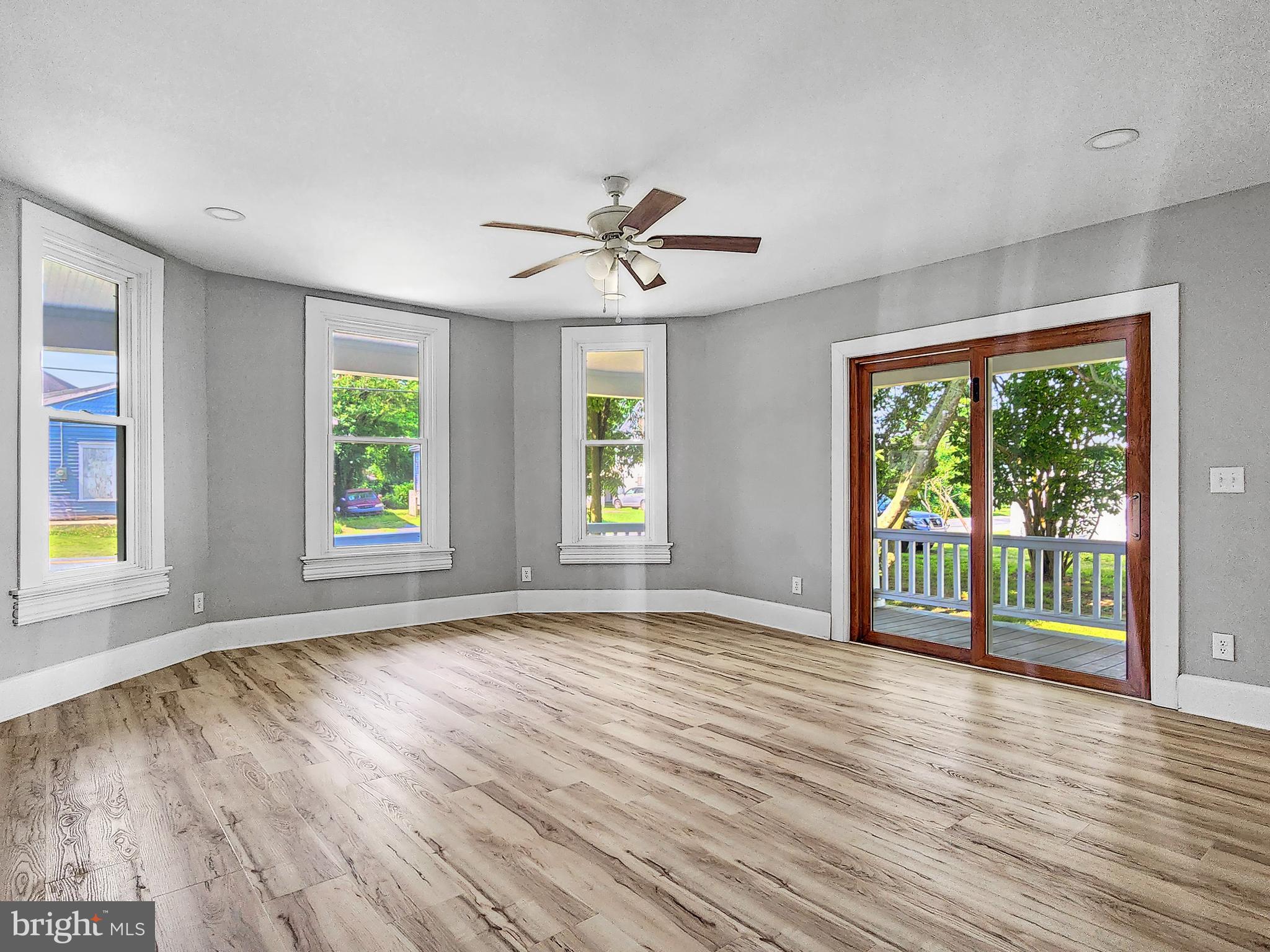 30181 Temperanceville Road Temperanceville, VA 23442 - Photo 5 of 41 an empty room with wooden floor and windows
