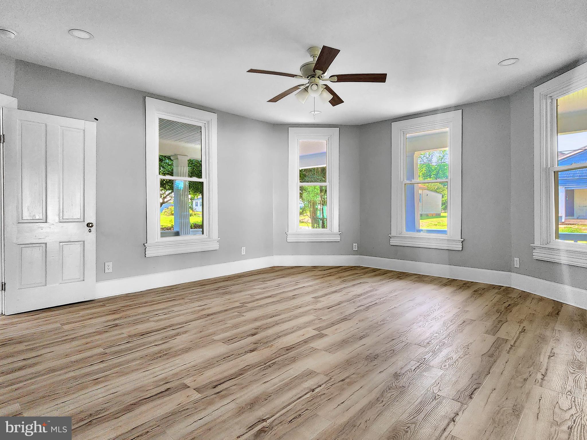 30181 Temperanceville Road Temperanceville, VA 23442 - Photo 6 of 41 a view of an empty room with window and wooden floor