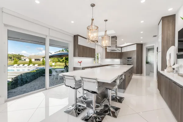a large kitchen with a table and chairs